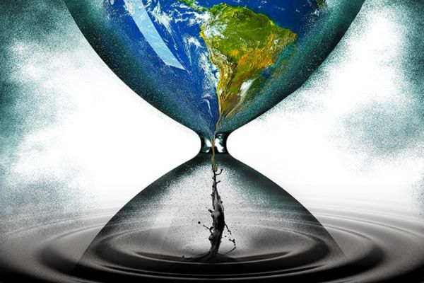 hourglass with earth at the top turning into oil at the bottom